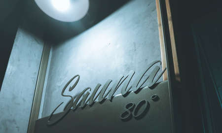 Sauna volumetric lettering decoration inscription at the spa hotel. Entrance sign Sauna title type at the wellness center, closeup.の写真素材
