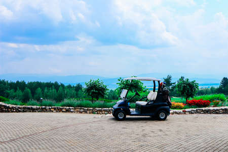 Golf cart, beautiful green course fields, luxury sport lifestyle concept.の写真素材