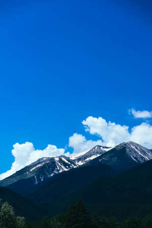 Beautiful alpine ice mountains peaks with snow, summer time, blue sky background.の写真素材
