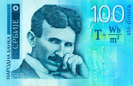 Serbian 100 dinara currency banknote, close up. Serbia money RSD dinar cash, macro view, portrait of scientist Nikola Tesla.の写真素材