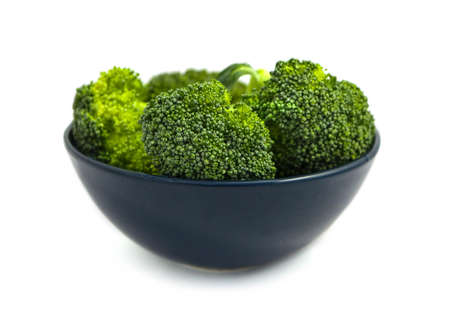 Branch of fresh tasty green broccoli cabbages in a plate. A bright colorful natural beautiful...