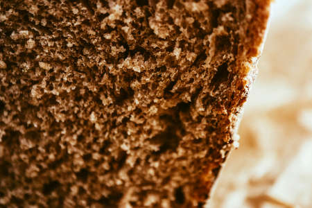 A piece of handmade freshly baked rye bread, texture background, closeup.の写真素材