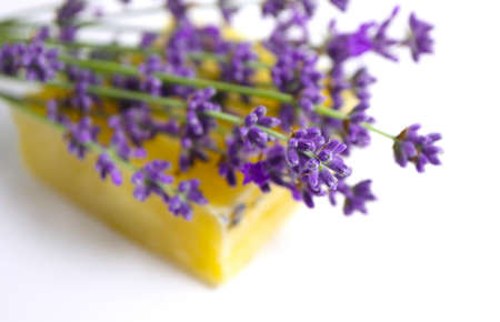 A herbal homemade soap with lavender flower bunch, isolated on white background.の写真素材