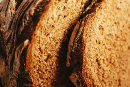 A piece of handmade freshly baked rye bread, texture background, closeup.の写真素材