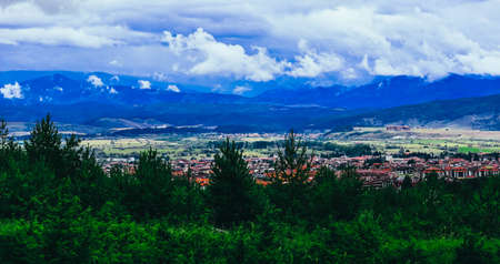 Alpine village in a mountains, landscape. Europe, old town panoramic view, red roofs houses.の写真素材