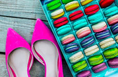 Pink shoes and a macaroons box. Luxury temptation concept.の写真素材