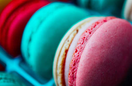 Assorted macaroons sweets, close up, backdrop. Marine, pink and violet.