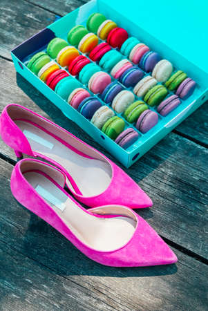 Pink shoes and a macaroons box. Luxury temptation concept.の写真素材
