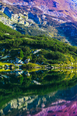 Amazing alpine lake in the high mountains, sunrise. Beautiful fiord mountain, river, hiking scenic...