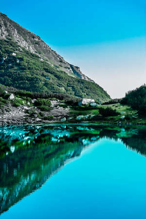 Amazing alpine lake in the high mountains. Beautiful fiord mountain, river, hiking scenic landscape, summertime.の写真素材