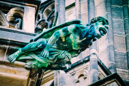 Czech architecture, scary gargoyle sculpture, gothic temple decoration. Medieval art, mystic gargoyle monster statue, St. Vitus Cathedral.の写真素材