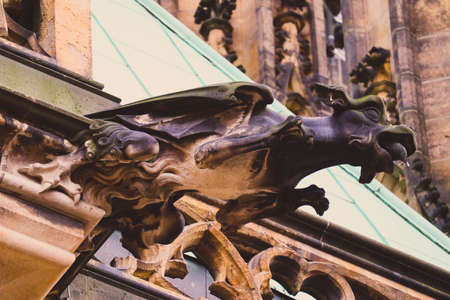 Czech architecture, scary gargoyle sculpture, gothic temple decoration. Medieval art, mystic gargoyle monster statue, St. Vitus Cathedral.の写真素材