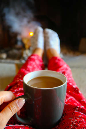 Coffee cap, firewood fire on the background. Bright colorful flame, burning wood at the fireplace,...