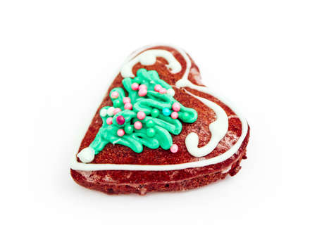 Homemade gingerbread Christmas cookie in a shape of heart, isolated on white. Holiday decoration, winter time food.の写真素材