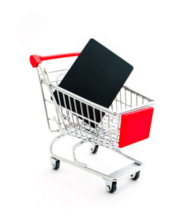 Shopping cart with a black card purchased, isolated on white background. Consumption, bad shopping concept, pushcart.の写真素材