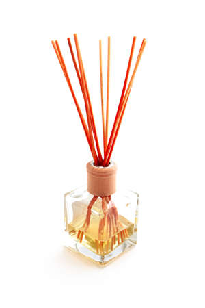 Home perfume in a glass bottle with wooden sticks, isolated on white background. Elegant spa decoration, luxury air fresher, Asian style.の写真素材