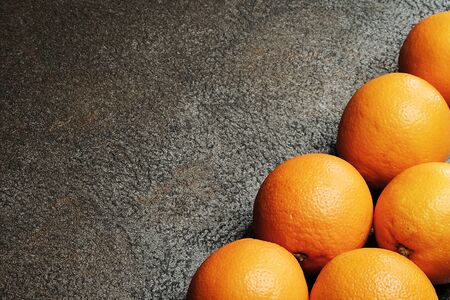 Fresh oranges on dark background