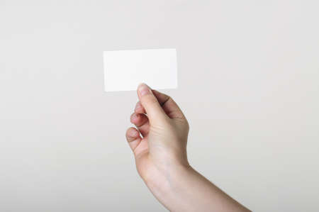  Hand with white card on a white backgroundの写真素材