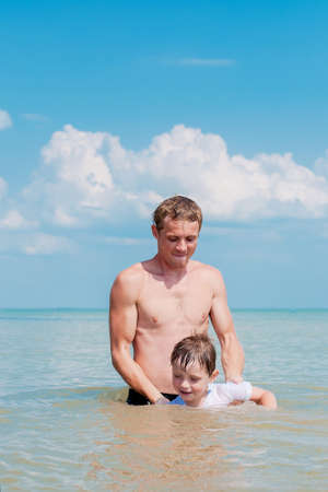 Little boy and his father in the sea waterの写真素材