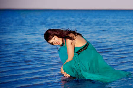  Young girl on the beach in beautiful long dressの写真素材