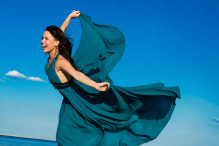  Young girl on the beach in beautiful long dressの写真素材