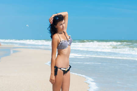  Young beautiful girl in a bikini on a beachの写真素材