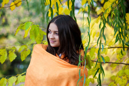 Young beautiful girl in autumn parkの写真素材