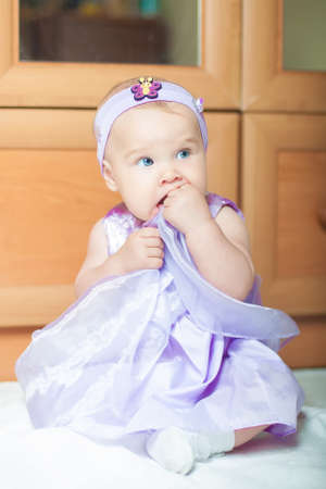 Little girl in a beautiful dress at homeの写真素材