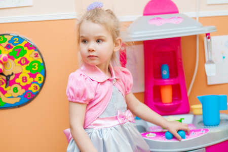 Little girl playing with toys in the playroomの写真素材