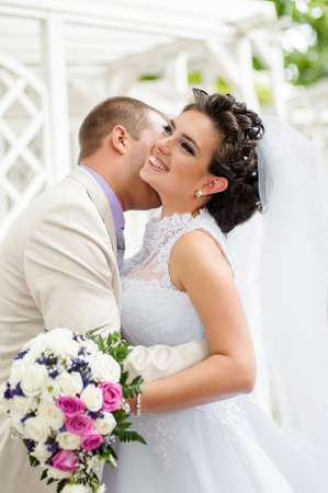 Young and beautiful bride and groom smillingの写真素材