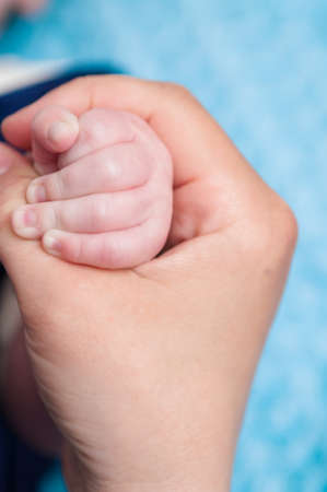 Small baby hand in mother's hand closeupの写真素材