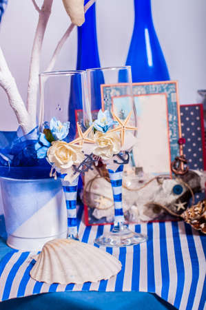 Decoration on the marine theme with seashells, fish, bottles and glassesの写真素材