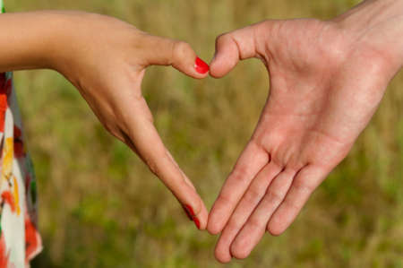 Hands folded pair of heart-shaped on nature