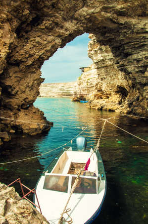 Boat on a mooring in the sea cliffsの写真素材