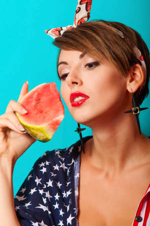 Young beautiful girl with watermelon in handsの写真素材