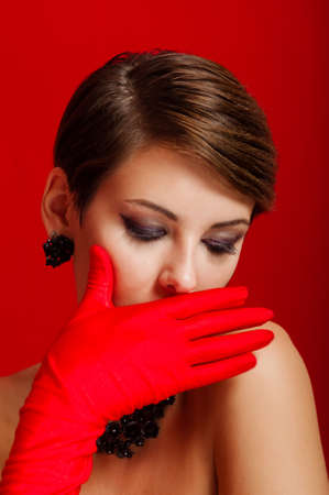  Beautiful girl in red gloves and jewelryの写真素材