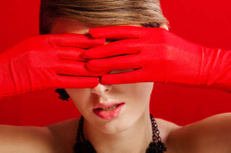  Beautiful girl in red gloves and jewelryの写真素材