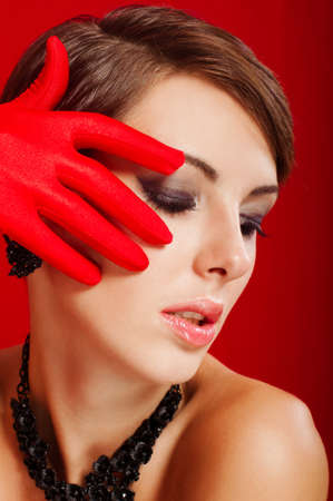  Beautiful girl in red gloves and jewelryの写真素材