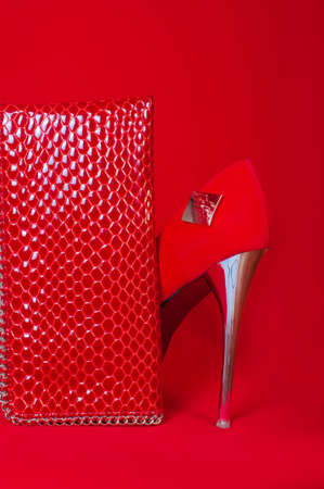 Red high heels and purse on a red backgroundの写真素材