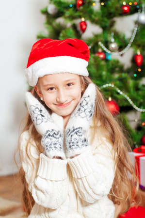 Little girl with long hair near a Christmas treeの写真素材