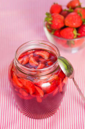Jar of strawberry jam on the table