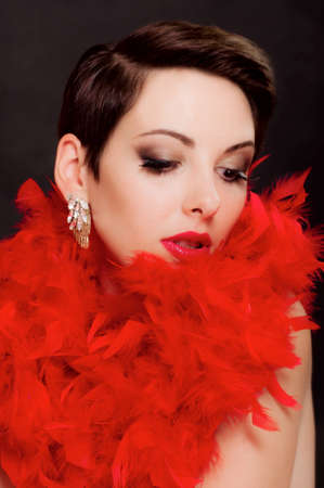 Beautiful girl in boa with a bright makeupの写真素材