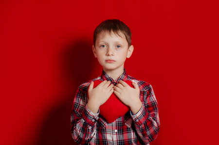 little boy with a heart of toy  in handsの写真素材
