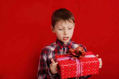 Little boy with a  gift box in handsの写真素材