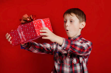 Little boy with a  gift box in handsの写真素材