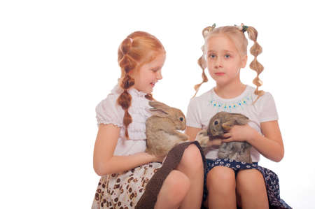 Little girls  with a rabbits  in her hands