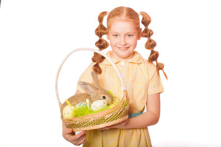 Little girl with a rabbit in a basket easter eggs