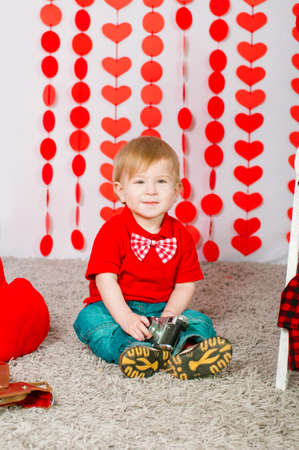 Little boy with red decorations on Valentineの写真素材