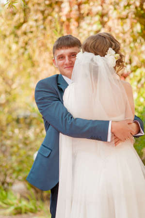 The bride and groom in summer park huggingの写真素材