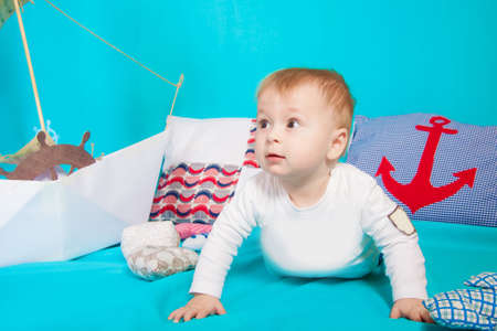 Child in blue with sea shells and decor